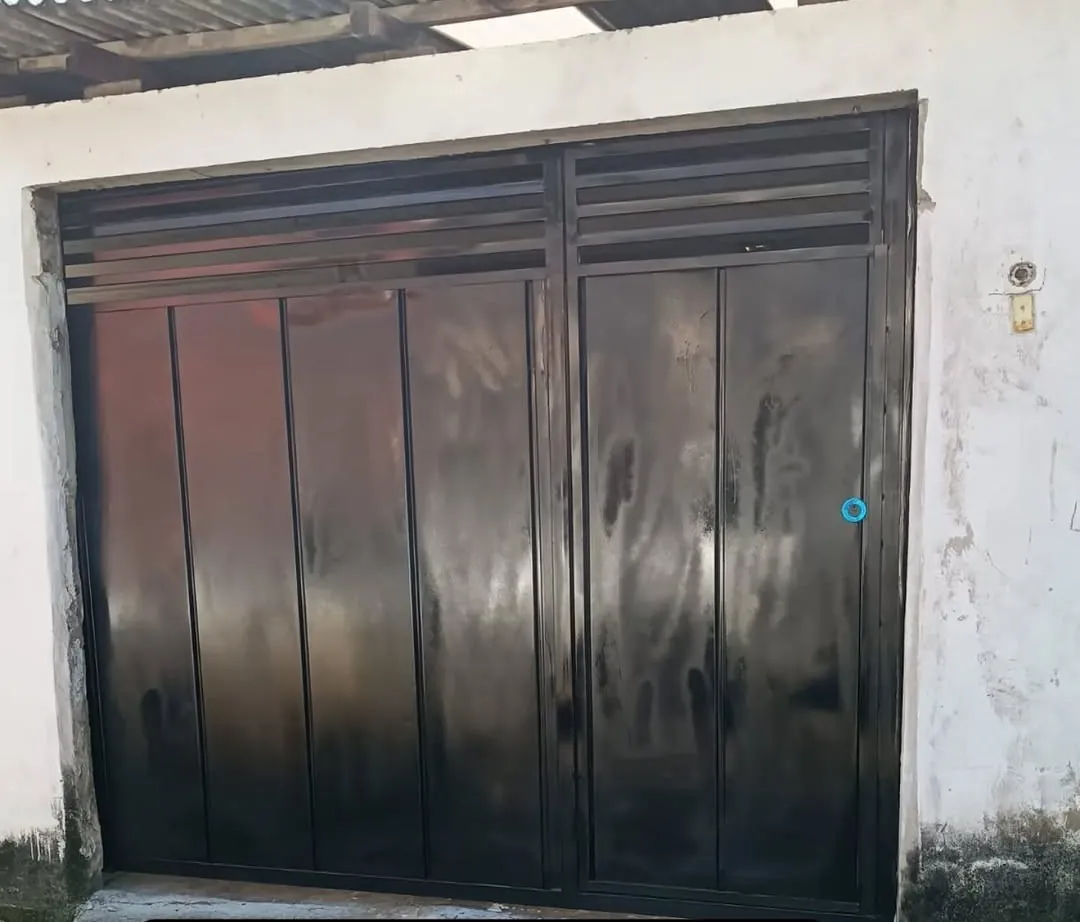 Portão preto de duas folhas com veneziana em cima